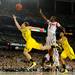 Michigan freshman Spike Albrecht attempts a layup around Louisville junior Russ Collins during the second half of the national championship game at the Georgia Dome in Atlanta on Monday, April 8, 2013. Melanie Maxwell I AnnArbor.com